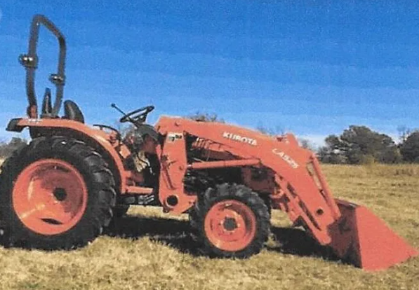 Orange agricultural tractor field use